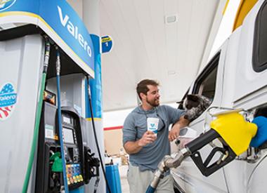 Customer with dog at Valero gas pump