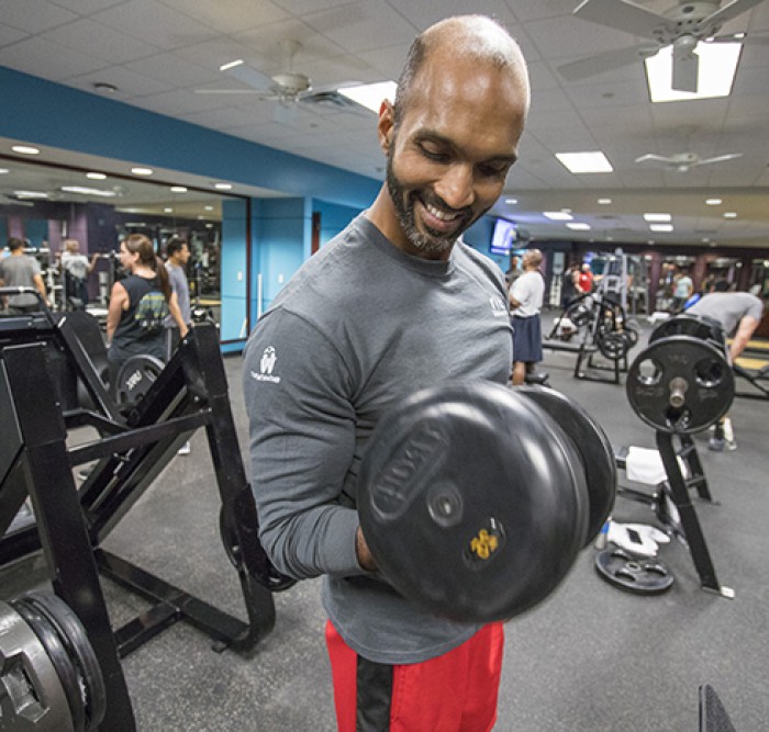 Employee lifting weights in gym