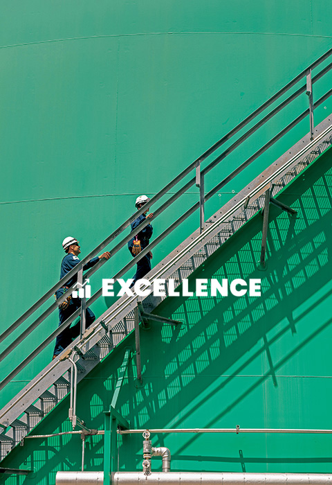 Two Valero employees climb a staircase. Text in the photo reads "EXCELLENCE."
