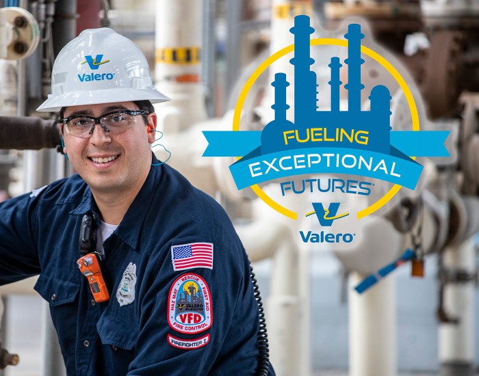 A Valero refinery employee smiles in front of equipment. To his left is Valero's Fueling Exceptional Futures logo, featuring a silhouette of a refinery in blue, surrounded by a thin yellow circle. Within the circle is a blue banner with blue, yellow and white text that reads FUELING EXCEPTIONAL FUTURES. Beneath this is the Valero logo, accompanied by the Valero company name.